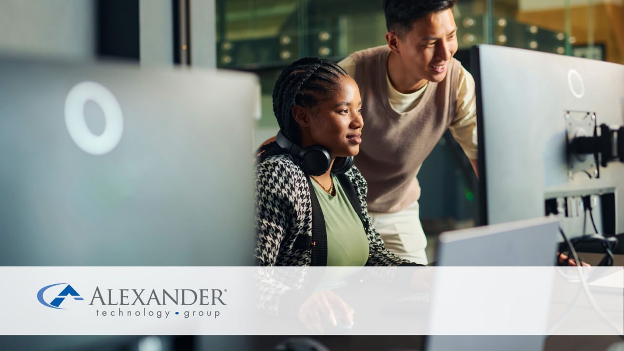 man and woman looking at a desktop computer