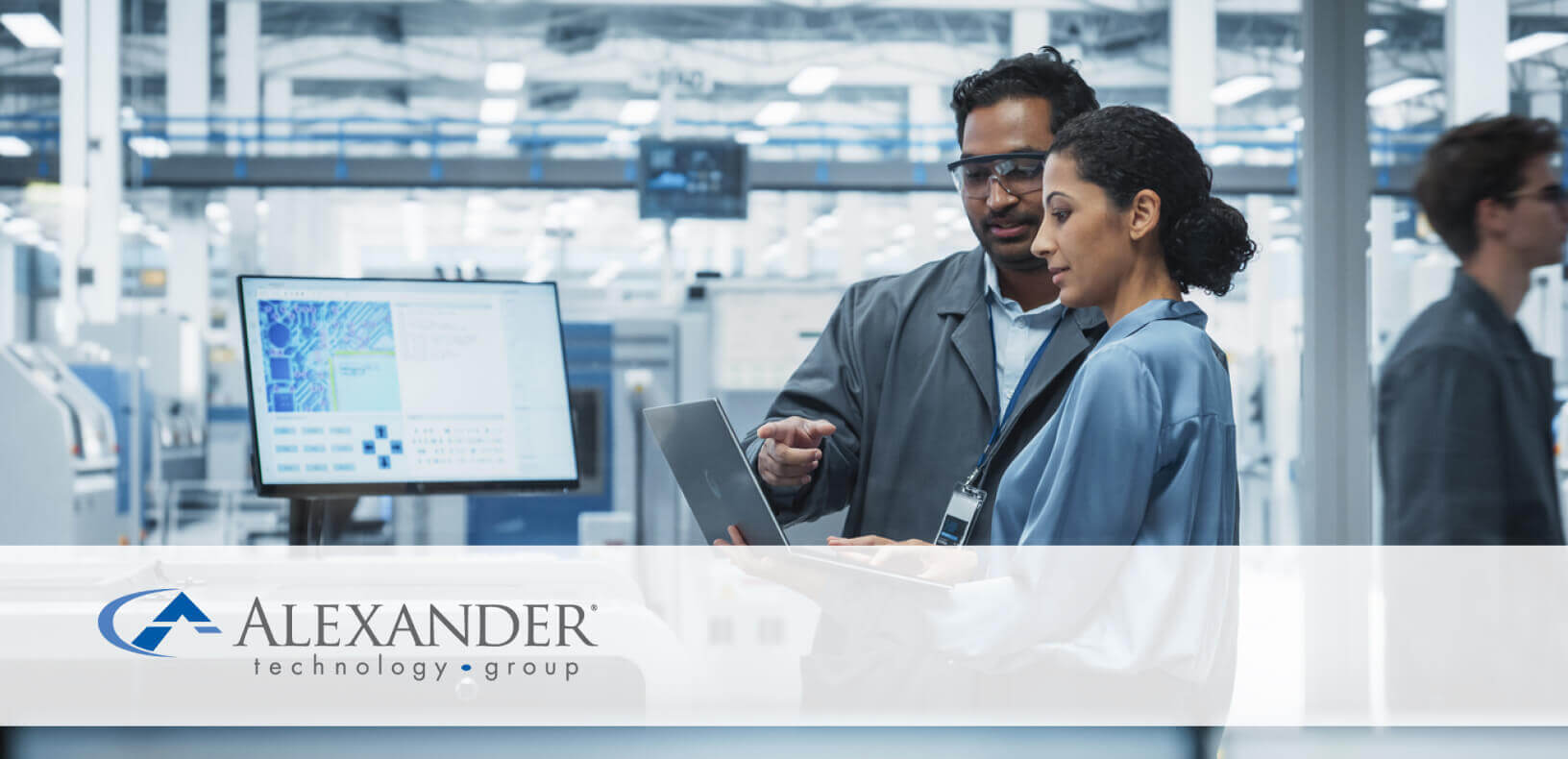 two people looking at a computer in a warehouse